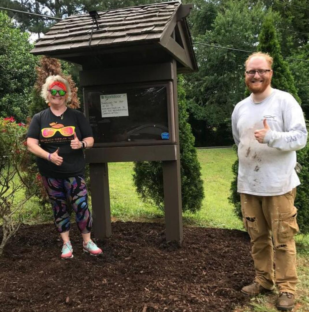 Fresh stain, new solar light, and mulch for info sign